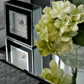 clock on nightstand with flowers staging